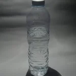 A single plastic bottle of water photographed against a plain background