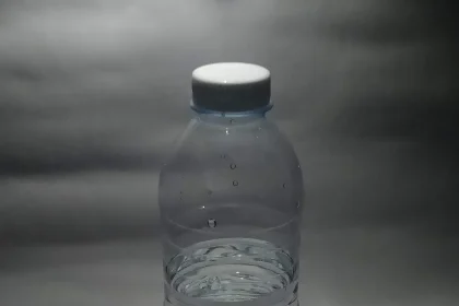 A single plastic bottle of water photographed against a plain background