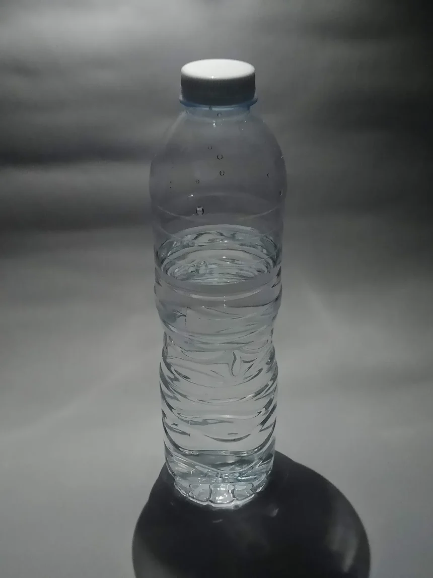 A single plastic bottle of water photographed against a plain background