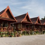 A row of wooden houses raised on stilts with terraces