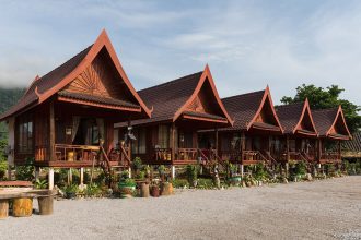 A row of wooden houses raised on stilts with terraces